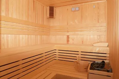 a wooden sauna with a tub and a trash can at Вила Релакс in Pamporovo