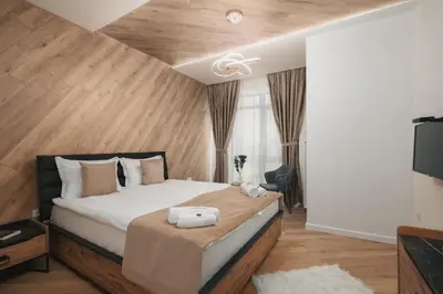 a bedroom with a large bed and a television at Mountain View in Govedartsi