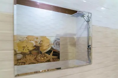a bathroom with a shower with a painting on the wall at Свети Никола in Razlog