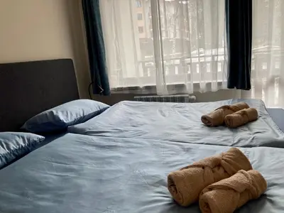 two stuffed animals laying on top of a bed at Cactus Apartment in Borovets