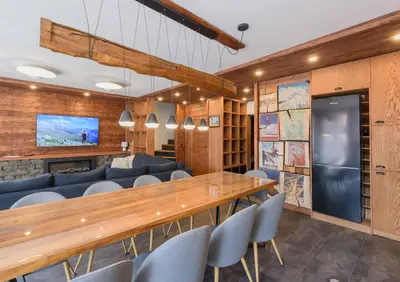a dining room with a long table and chairs at Finest Luxury Penthouse Bansko Royal Towers in Bansko