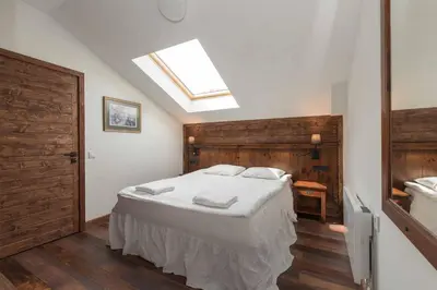 a bedroom with a large bed with a skylight at Finest Luxury Penthouse Bansko Royal Towers in Bansko