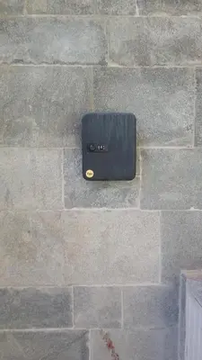 a brick wall with a black box on it at Синьо небе in Bansko