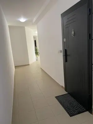 a hallway with a black door and a tile floor at Lovely Аpartment in IGLIKA 2,Borovets in Borovets