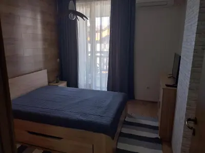 a bedroom with a blue bed with a window at St John Park Boutique room Gero in Bansko