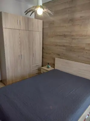 a bedroom with a bed and wooden walls at St John Park Boutique room Gero in Bansko