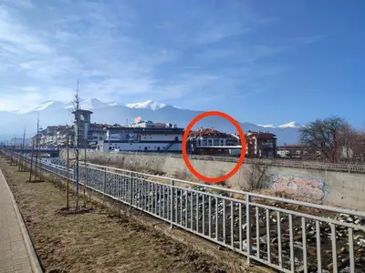 a red circle is sitting on the side of a fence at Gondola studio ENA in Bansko