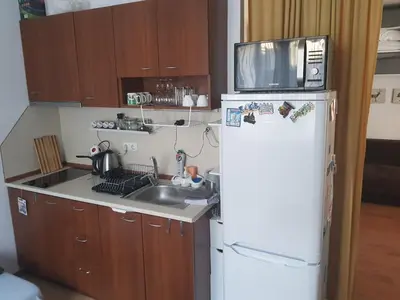 a small kitchen with a white refrigerator and a sink at Gondola studio ENA in Bansko