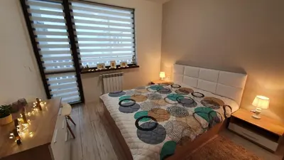 a bedroom with a large bed and a window at Borovets Cozy Mountain Apartments in Borovets