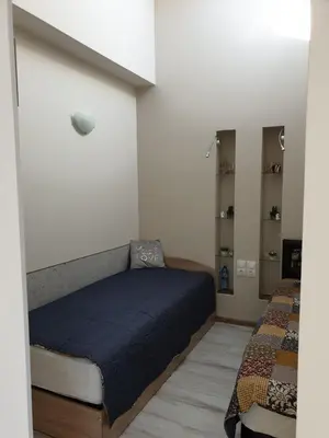 a bedroom with a bed with a blue comforter at Borovets Cozy Mountain Apartments in Borovets