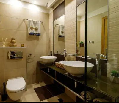 a bathroom with two sinks and a toilet at Silver city Paradise in Sofia