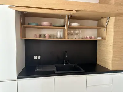 a kitchen with a sink and a black counter top at Silver city Paradise in Sofia