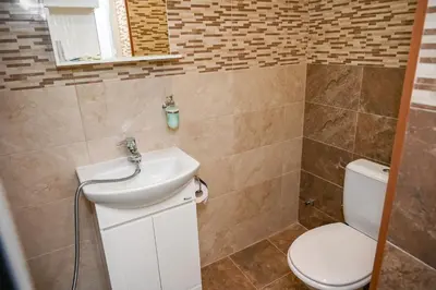 a bathroom with a toilet and a sink at The White Horse Apartments in Borovets