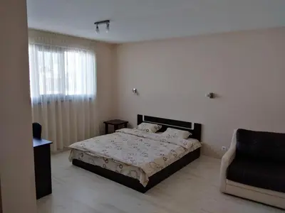 a bedroom with a bed and a chair in it at Sveti Nikola Villas near Borovets in Shiroki Dol