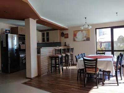 a kitchen and dining room with a table and chairs at Sveti Nikola Villas near Borovets in Shiroki Dol