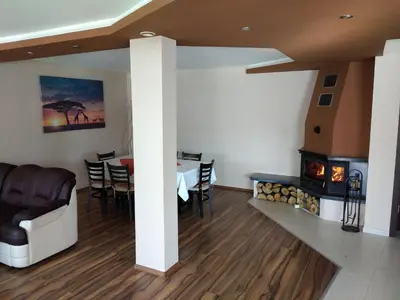a living room with a table and a fireplace at Sveti Nikola Villas near Borovets in Shiroki Dol
