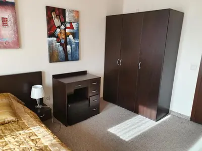 a bedroom with a bed and a dresser and a cabinet at Spacious and Cosy Apartment in Bansko Royal Towers Complex in Bansko