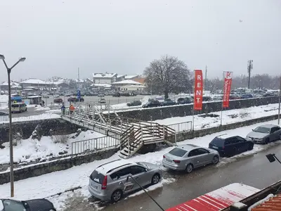 a parking lot with cars parked in the snow at Spacious and Cosy Apartment in Bansko Royal Towers Complex in Bansko