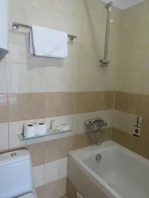 a bathroom with a bath tub and a toilet at Flora Violet Studio Apartment nr 10 in Borovets