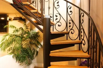 a black spiral staircase with a plant at Top Center Vintage Sofia Condo in Sofia