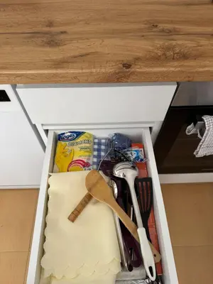 a drawer with utensils and other items in a kitchen at Relax&Ski apartment in Bansko