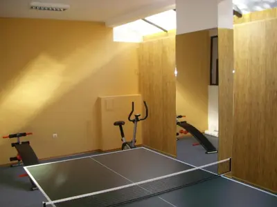 a gym with a ping pong table in a room at Apartament Fantasy Hisarya in Hisarya