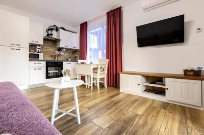 a living room with a couch and a table at Villa Nikol Apt #1 in Raduil