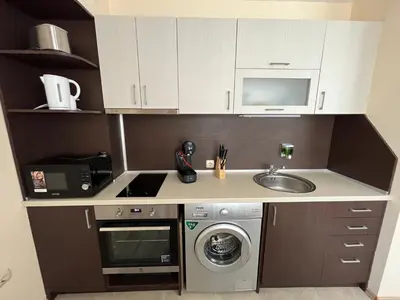 a small kitchen with a sink and a microwave at Marina Apartments - One Bedroom in Bansko
