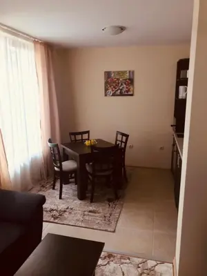 a dining room with a table and chairs at Marina Apartments - One Bedroom in Bansko