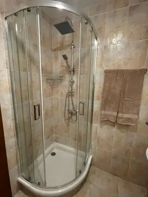 a shower with a glass door in a bathroom at Apartment in Castle 1 in Pamporovo