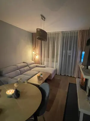 a living room with a couch and a table at Apartment in Castle 1 in Pamporovo
