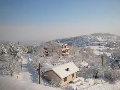 a house covered in snow on a mountain at Family Hotel Diana in Lyaskovo