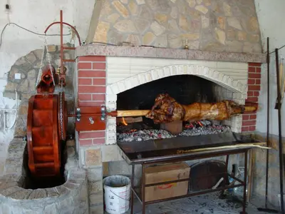 a brick oven with some food cooking in it at Family Hotel Diana in Lyaskovo