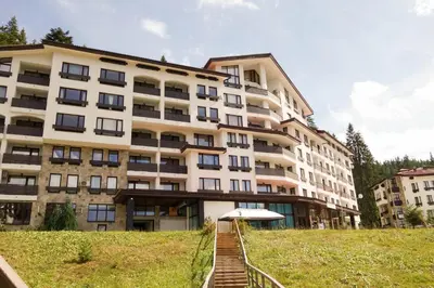 a large building with a staircase in front of it at Studio GERONIMO in Pamporovo