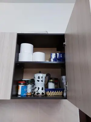 a cabinet filled with dishes and a tea pot at Studio GERONIMO in Pamporovo