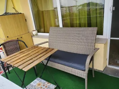 a chair and a table on a porch at Романтично Място Ани in Plovdiv
