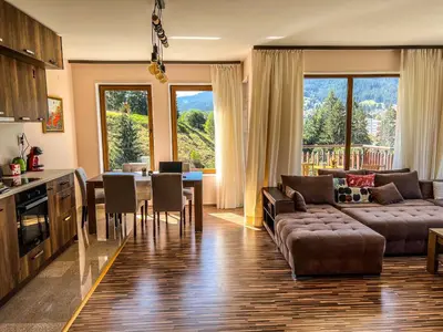 a kitchen and living room with a couch and a table at Ani's Guest House in Chepelare