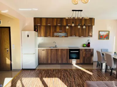 a kitchen with wooden cabinets and a white refrigerator at Ani's Guest House in Chepelare