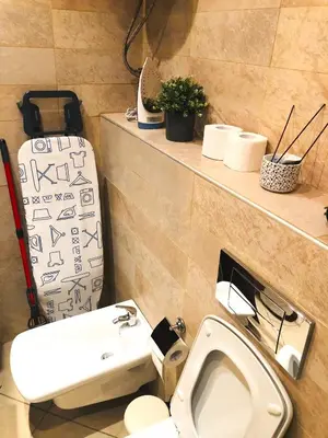 a bathroom with a toilet and a sink and a suitcase at Private Studio Center Opera and Nevski Cathedral in Sofia