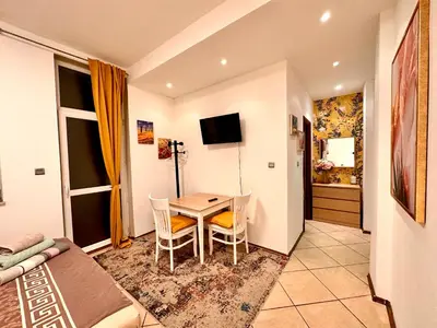 a small room with a table and a bedroom at Private Studio Center Opera and Nevski Cathedral in Sofia