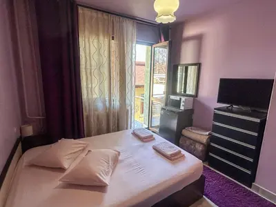 a bedroom with a large white bed with a window at Hotel Darling in Bankya