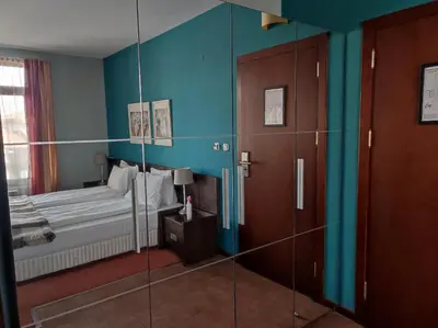 a bedroom with a bed and a glass wall at Hotel FAMIL - adults only in Bansko
