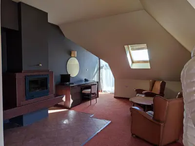 a room with a living room with a fireplace at Hotel FAMIL - adults only in Bansko