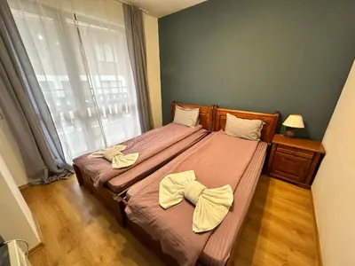 a bedroom with a bed with two bows on it at Pirin place private apartment in Bansko