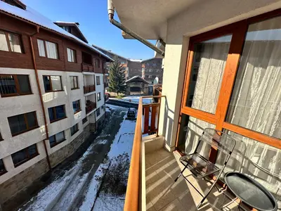 an empty balcony of a building with snow on the ground at Pirin place private apartment in Bansko