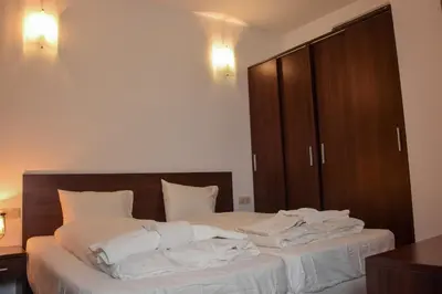 a bedroom with a bed with white towels on it at Dinos 2 Bed Cozy Apart at Bansko close to the lift in Bansko