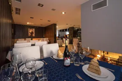 a table with glasses and a bottle of wine on it at Dinos 2 Bed Cozy Apart at Bansko close to the lift in Bansko