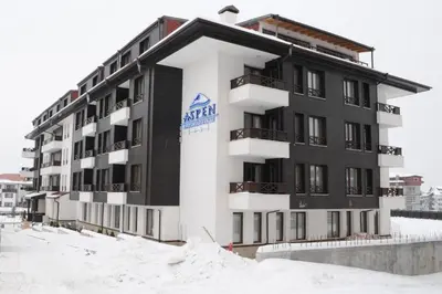 a large building with snow in front of it at Dinos 2 Bed Cozy Apart at Bansko close to the lift in Bansko