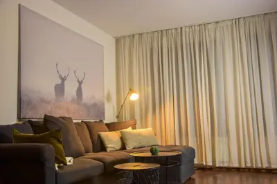 a living room with a couch and two tables at Dinos 2 Bed Cozy Apart at Bansko close to the lift in Bansko