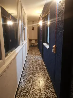 a hallway with blue walls and a tile floor at Homey art apartment next to Drujba lake Metro stations and bul.Tsarigradsko Shose in Sofia